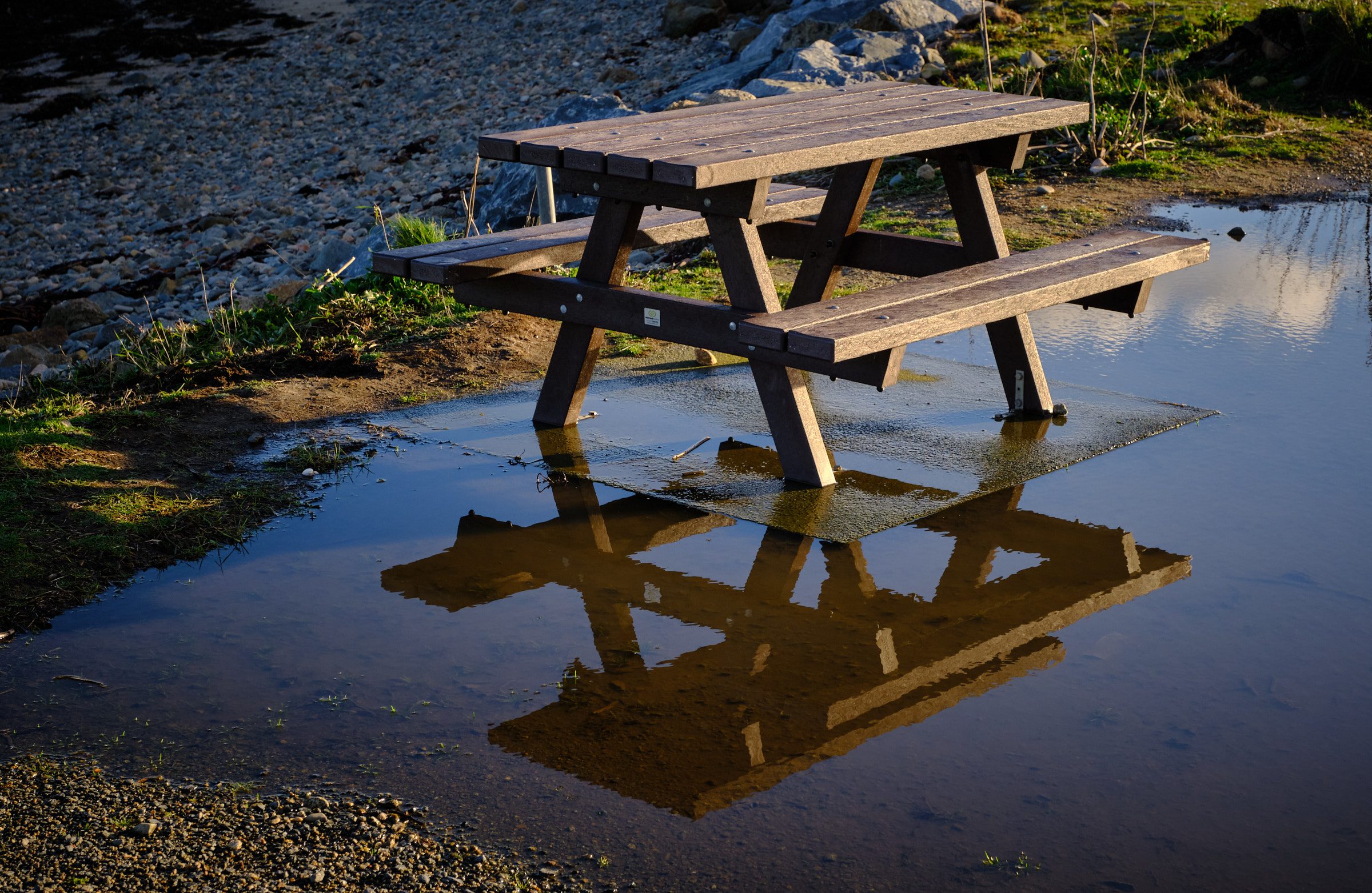 Picnic bench in puddle